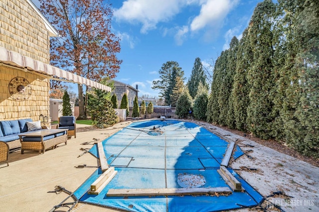 view of swimming pool with a patio, a diving board, a fenced backyard, and a fenced in pool