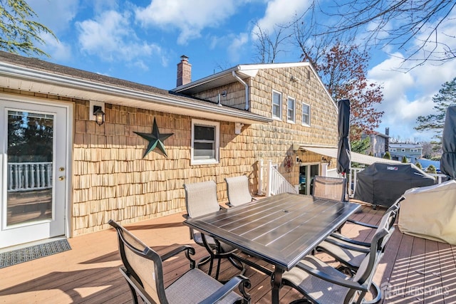 wooden deck featuring outdoor dining space and grilling area