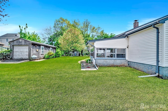 view of yard with an outbuilding and a garage