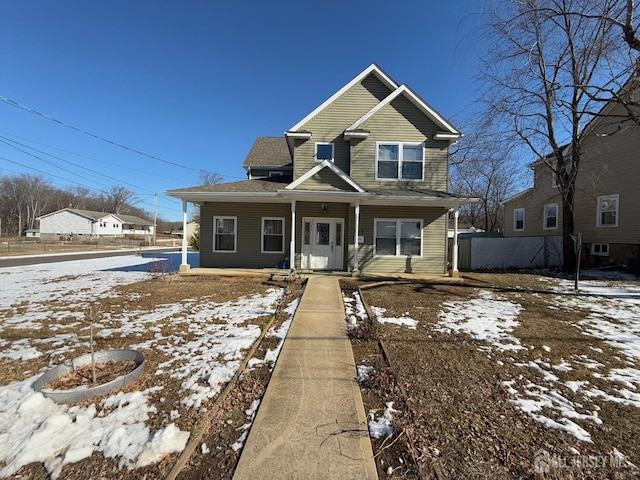 view of front of home with covered porch and fence