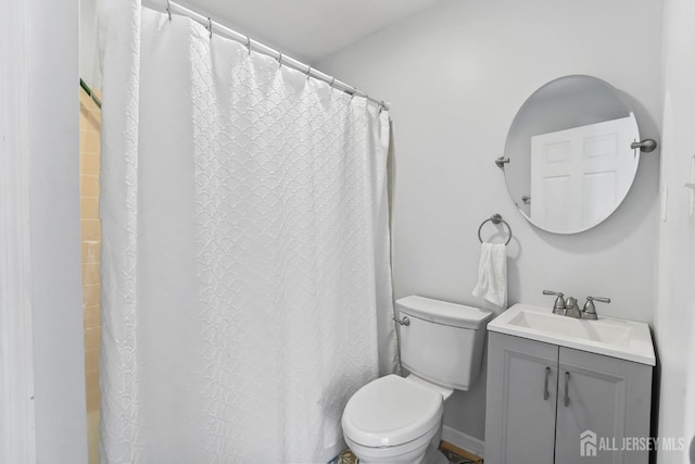 bathroom featuring vanity, a shower with shower curtain, and toilet