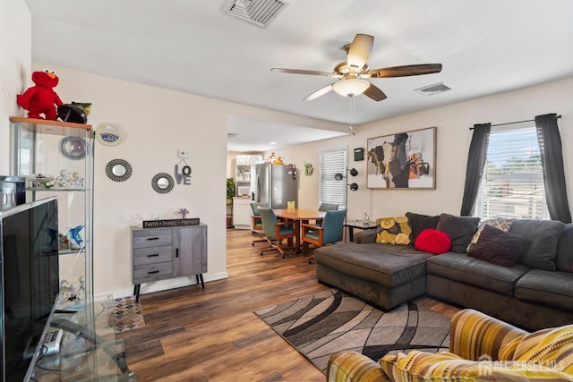 living room with dark hardwood / wood-style floors and ceiling fan