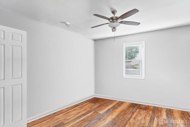 spare room with hardwood / wood-style floors and ceiling fan