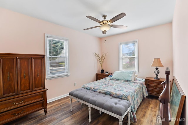 bedroom featuring dark hardwood / wood-style flooring, multiple windows, and ceiling fan