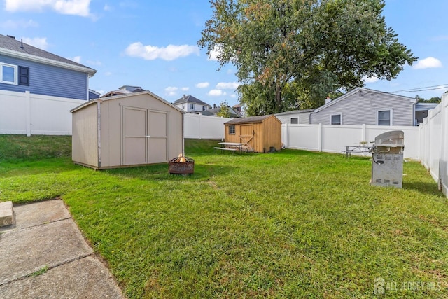 view of yard featuring a fire pit and a shed