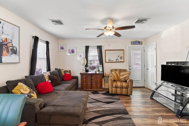 living room featuring dark hardwood / wood-style flooring and ceiling fan