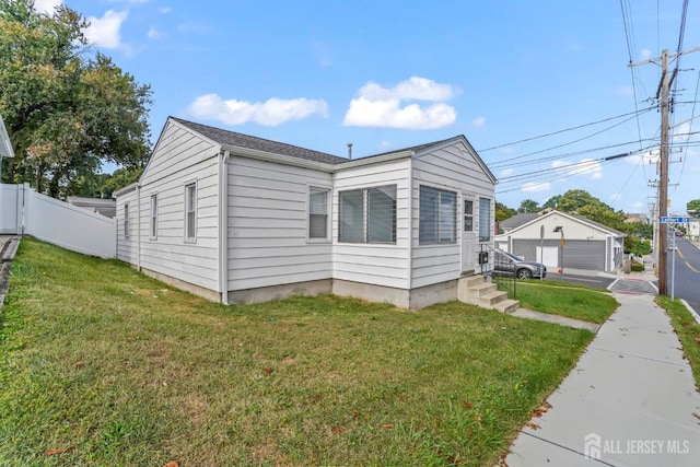 view of property exterior featuring a garage and a lawn