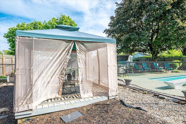 view of outbuilding with fence and a community pool
