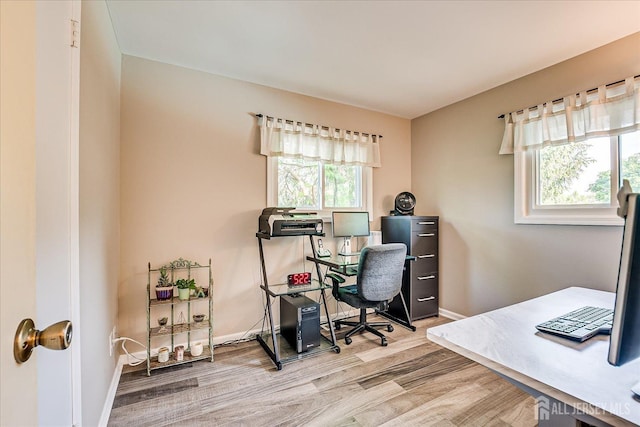 office with wood finished floors and baseboards