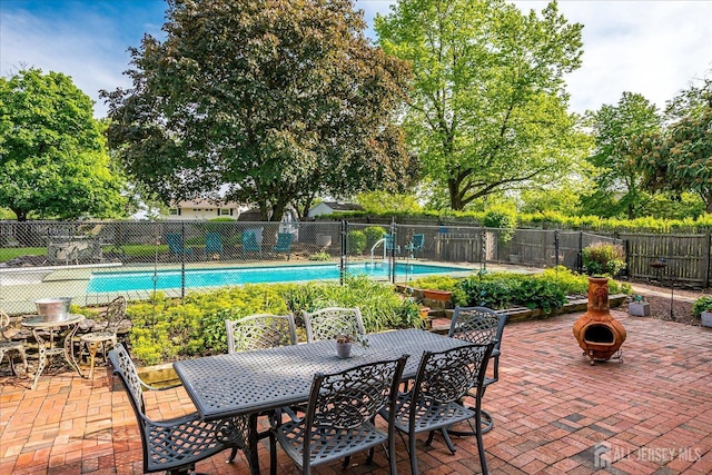 view of patio featuring fence, an outdoor fire pit, and outdoor dining area