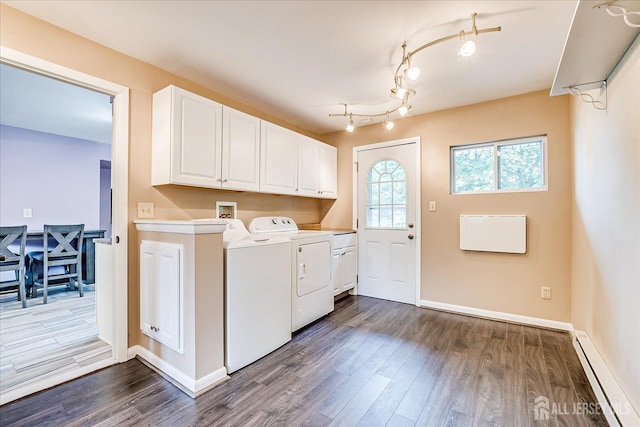 washroom with cabinet space, baseboard heating, washing machine and clothes dryer, dark wood-style floors, and baseboards