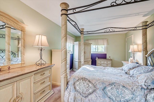 bedroom with light carpet and baseboards
