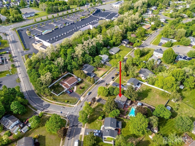 aerial view of property and surrounding area with nearby suburban area