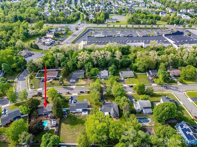 aerial view of property and surrounding area with nearby suburban area