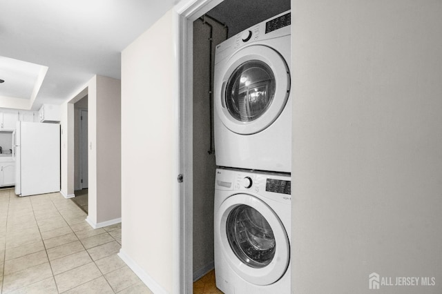31 Hanover Sq, Middlesex, NJ 08846 - laundry room with stacked washer / drying machine and light tile patterned flooring