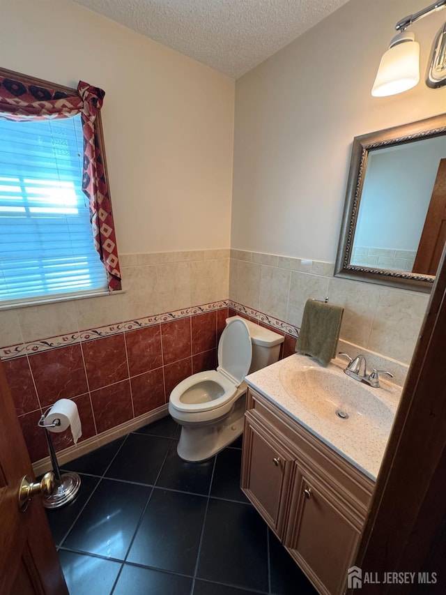 32 Gere Pl, Fanwood, NJ 07023 - bathroom featuring tile walls, vanity, a textured ceiling, wainscoting, and tile patterned flooring