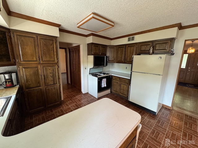 32 Gere Pl, Fanwood, NJ 07023 - kitchen featuring freestanding refrigerator, gas range, brick patterned floors, light countertops, and ornamental molding