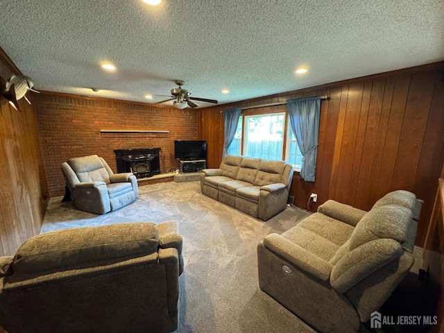 32 Gere Pl, Fanwood, NJ 07023 - living room with carpet, a textured ceiling, a brick fireplace, wooden walls, and a ceiling fan