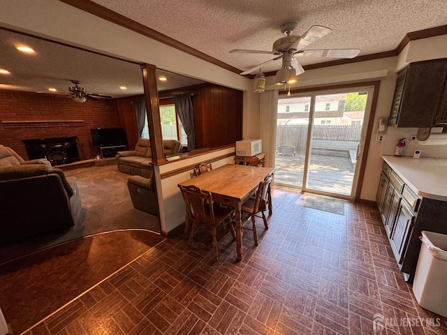 32 Gere Pl, Fanwood, NJ 07023 - dining area featuring a ceiling fan, a brick fireplace, healthy amount of natural light, a textured ceiling, and brick patterned floors