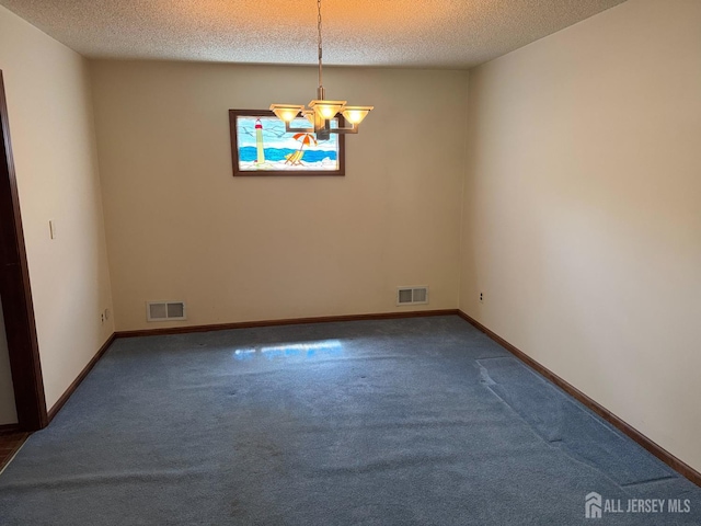 32 Gere Pl, Fanwood, NJ 07023 - empty room featuring dark colored carpet, a chandelier, and a textured ceiling