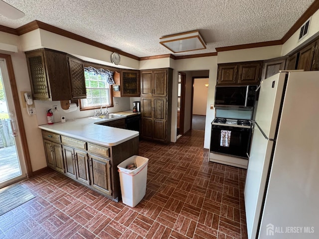 32 Gere Pl, Fanwood, NJ 07023 - kitchen with freestanding refrigerator, gas range oven, a peninsula, brick patterned flooring, and light countertops
