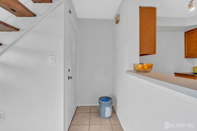 hallway with light tile patterned floors