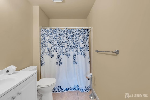 bathroom featuring toilet, vanity, and tile patterned floors