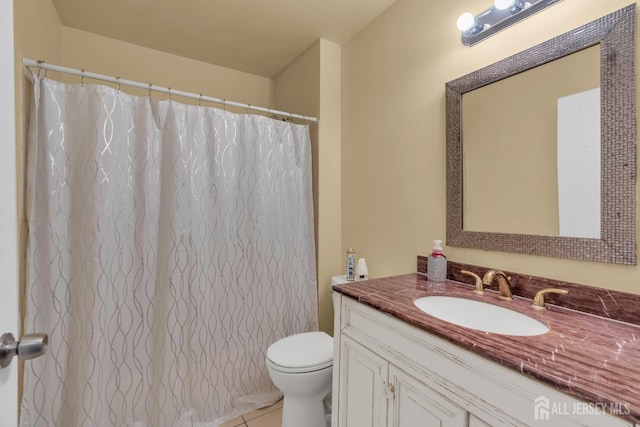 full bath featuring tile patterned flooring, vanity, and toilet