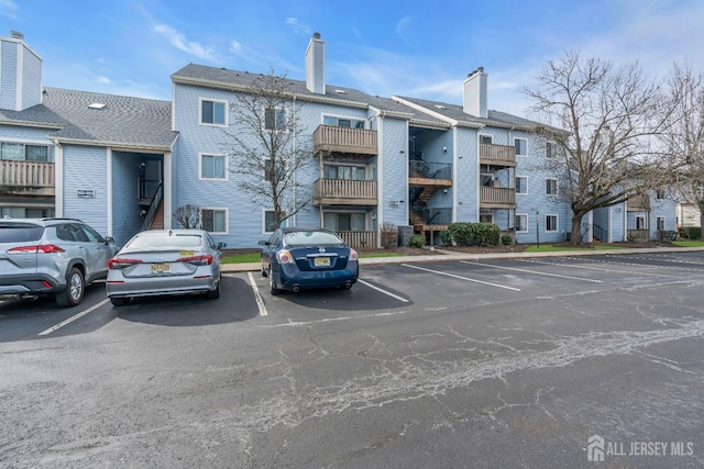 view of building exterior with uncovered parking