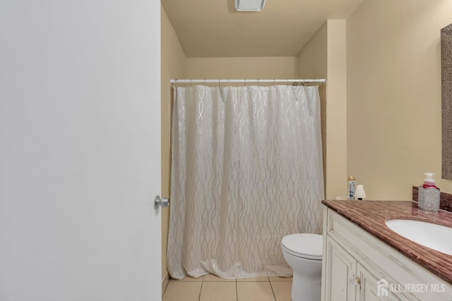 full bathroom with curtained shower, vanity, toilet, and tile patterned floors