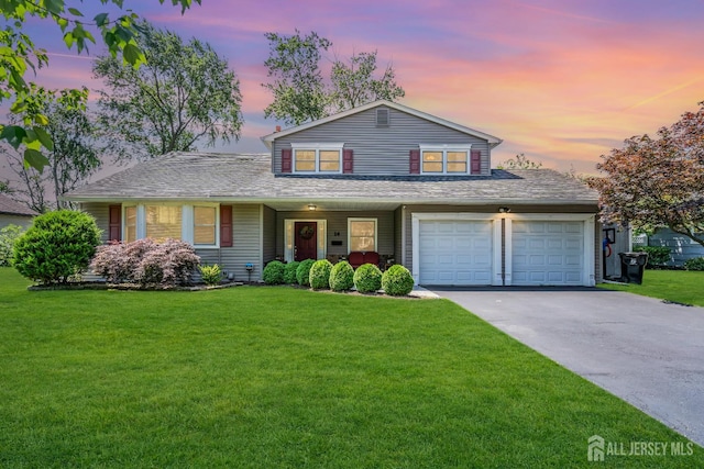 14 Academic Rd, East Brunswick, NJ 08816 - traditional-style house featuring a front lawn, an attached garage, and asphalt driveway