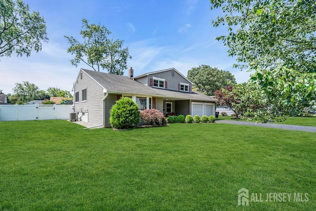 14 Academic Rd, East Brunswick, NJ 08816 - traditional home with a chimney, a garage, asphalt driveway, a gate, and roof with shingles