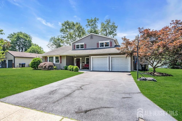 14 Academic Rd, East Brunswick, NJ 08816 - traditional home with asphalt driveway, a front yard, and an attached garage