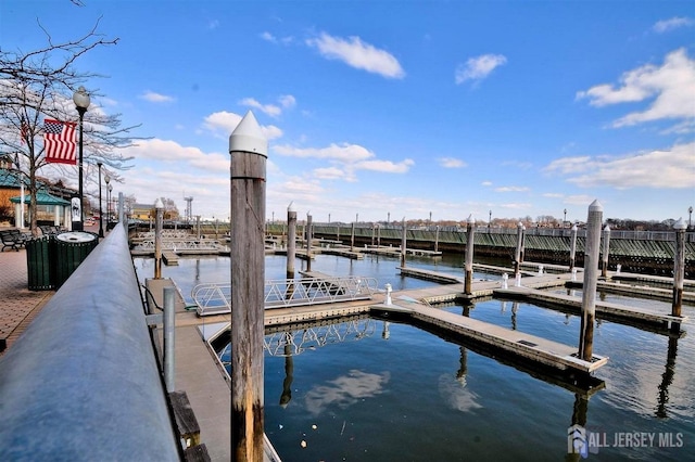 view of dock with a water view and central AC