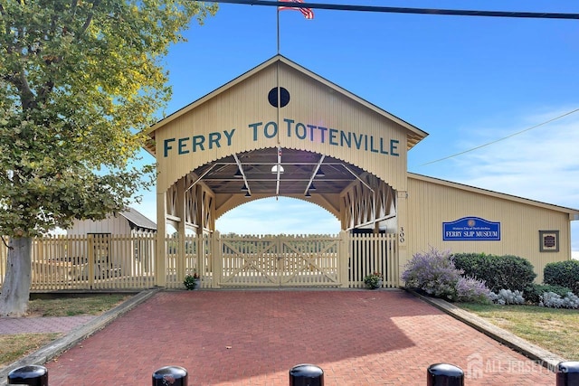 view of community with fence and a gate