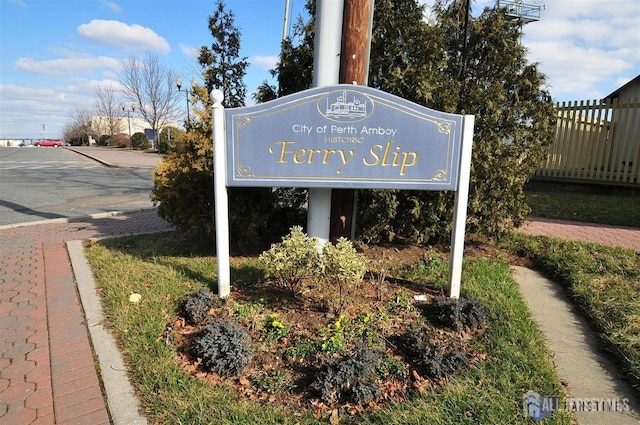 community / neighborhood sign with fence