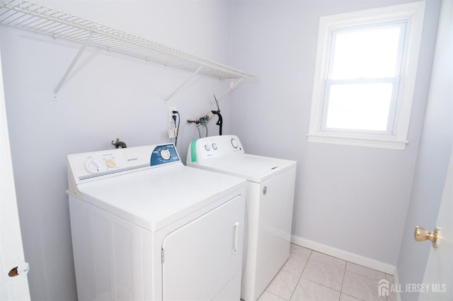 washroom featuring light tile patterned floors and separate washer and dryer