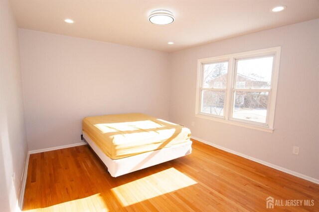 unfurnished bedroom with hardwood / wood-style floors