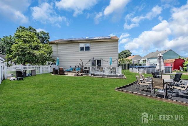 557 Howard Ave, Middlesex, NJ 08846 - rear view of house featuring a patio, solar panels, and a fenced backyard
