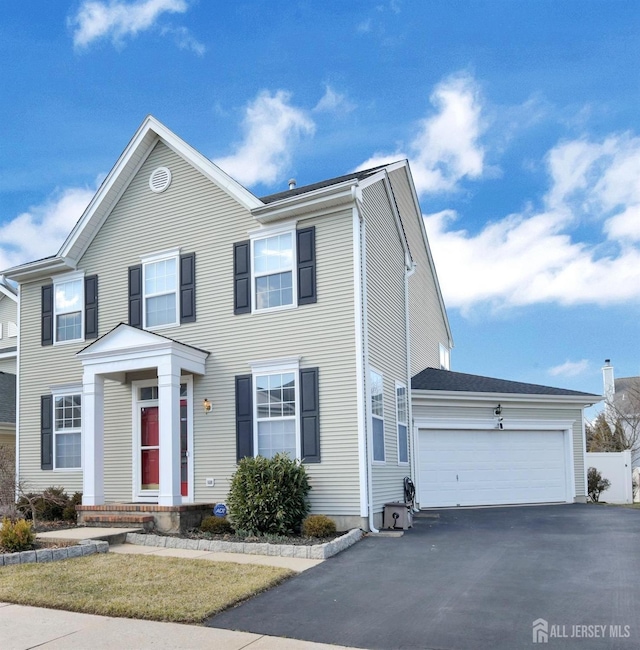 view of front of house with a garage and aphalt driveway