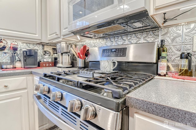 312 Bunnell Pl, Lacey, NJ 08731 - kitchen view of stainless steel gas range oven, decorative backsplash, white cabinets, white microwave, and light countertops