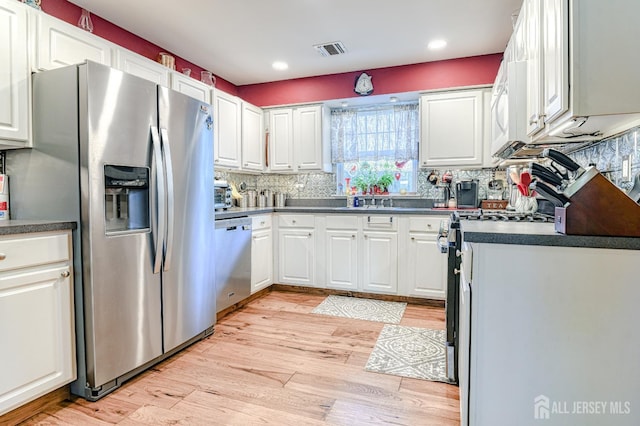 312 Bunnell Pl, Lacey, NJ 08731 - kitchen featuring appliances with stainless steel finishes, light wood-style flooring, dark countertops, tasteful backsplash, and recessed lighting