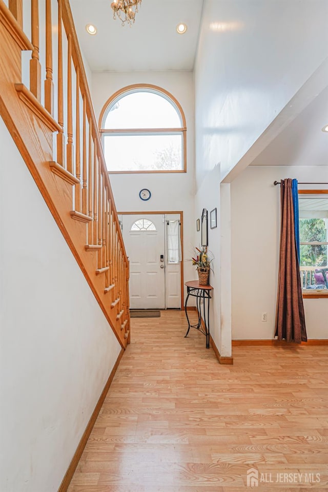 220 Raritan St, South Amboy, NJ 08879 - foyer entrance featuring a chandelier, light wood-style floors, a towering ceiling, stairway, and recessed lighting