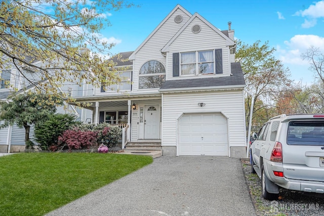 220 Raritan St, South Amboy, NJ 08879 - traditional home featuring a garage, a front yard, a chimney, driveway, and a shingled roof