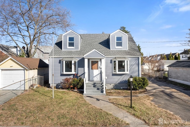 cape cod house with an outbuilding, a garage, and a front yard