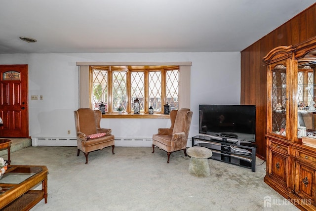 living area with carpet floors and a baseboard heating unit