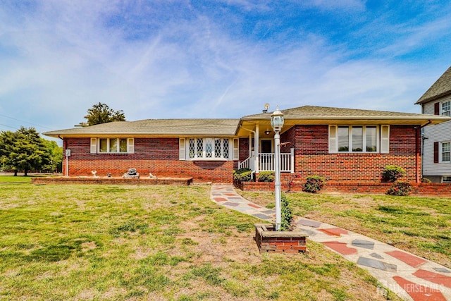 ranch-style house with a front yard and brick siding