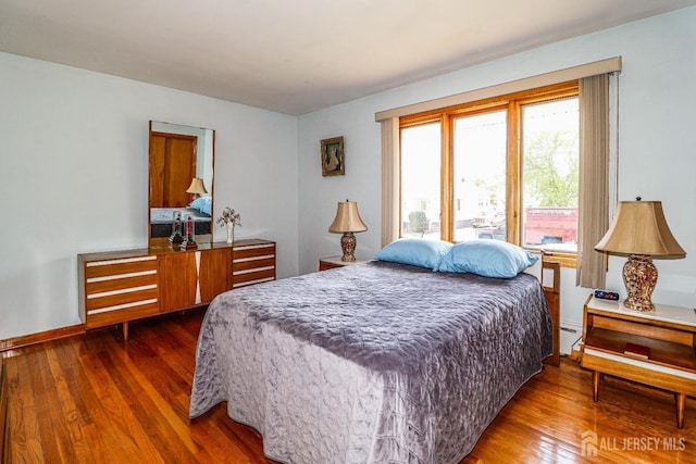 7 E 2nd St E, Port Reading, NJ 07064 - bedroom featuring dark wood-type flooring, baseboard heating, and baseboards
