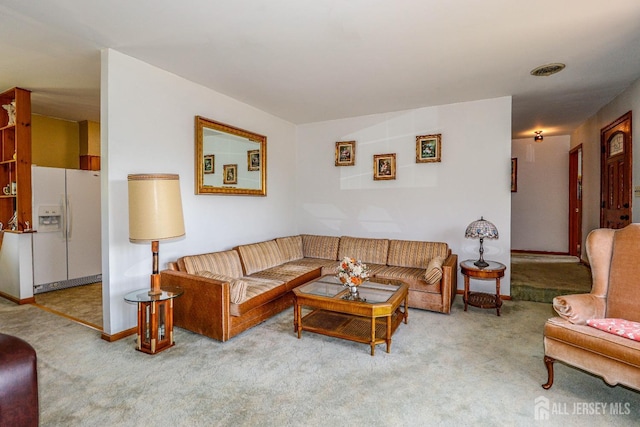 carpeted living room with baseboards and visible vents