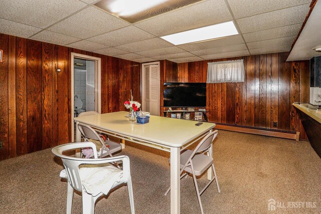 7 E 2nd St E, Port Reading, NJ 07064 - carpeted dining space featuring a paneled ceiling, a baseboard radiator, and wooden walls